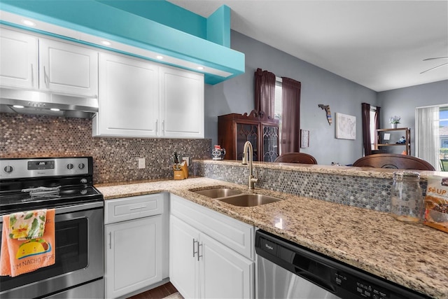 9407 Burnam Dr, Weeki Wachee, FL 34613 - kitchen with appliances with stainless steel finishes, exhaust hood, a sink, and white cabinets