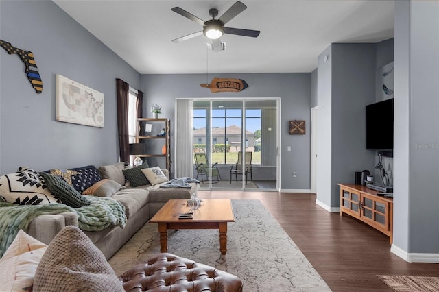9407 Burnam Dr, Weeki Wachee, FL 34613 - living room featuring a ceiling fan, dark wood-style floors, and baseboards