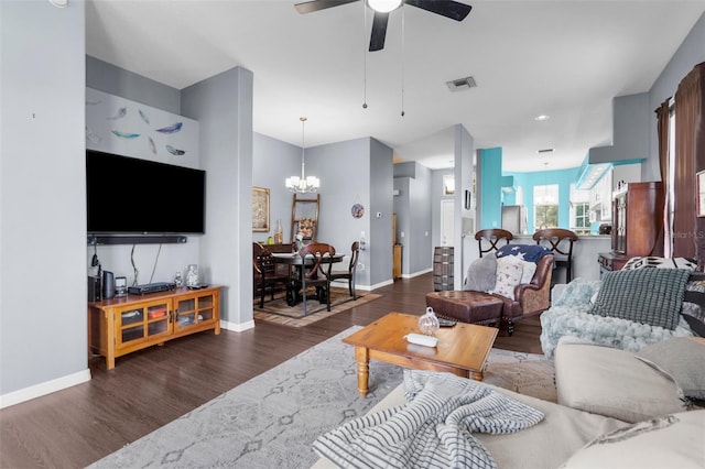 9407 Burnam Dr, Weeki Wachee, FL 34613 - living room with a chandelier, wood finished floors, ceiling fan, and baseboards