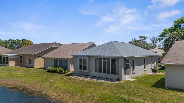 9407 Burnam Dr, Weeki Wachee, FL 34613 - rear view of house featuring a yard, stucco siding, and a shingled roof