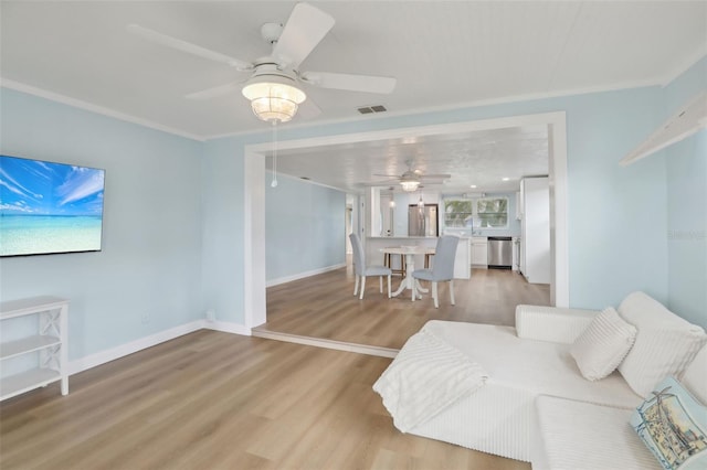 4942 Blue Heron Dr, New Port Richey, FL 34652 - living area featuring ceiling fan, light wood-style flooring, and baseboards