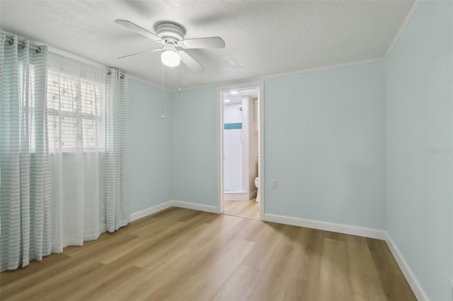 4942 Blue Heron Dr, New Port Richey, FL 34652 - unfurnished room featuring wood finished floors, ceiling fan, baseboards, and crown molding