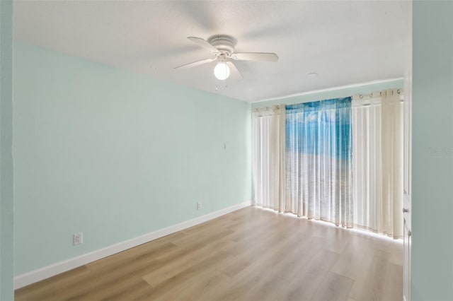 4942 Blue Heron Dr, New Port Richey, FL 34652 - empty room featuring wood finished floors, ceiling fan, and baseboards