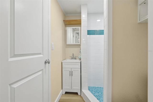 4942 Blue Heron Dr, New Port Richey, FL 34652 - full bathroom with vanity, a tile shower, wood finished floors, crown molding, and baseboards