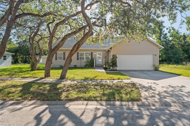 15613 Charmwood Dr, Hudson, FL 34667 - ranch-style home featuring a garage, a front lawn, and driveway