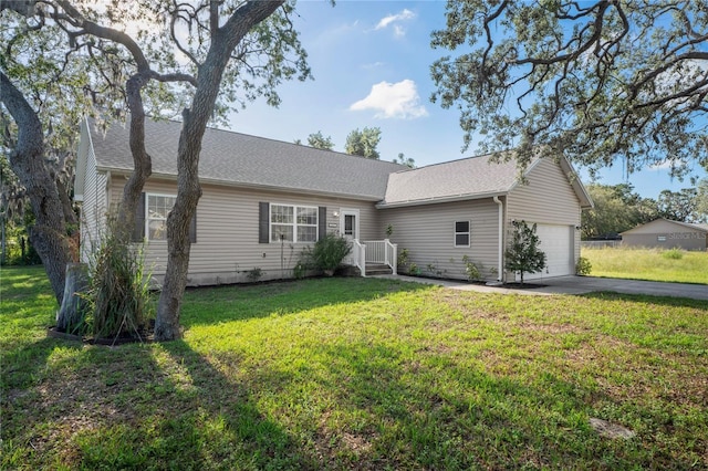 15613 Charmwood Dr, Hudson, FL 34667 - view of front of house with an attached garage, asphalt driveway, a front yard, and roof with shingles