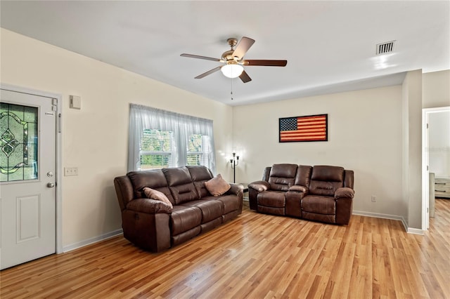 15613 Charmwood Dr, Hudson, FL 34667 - living room with light wood finished floors, a ceiling fan, and baseboards