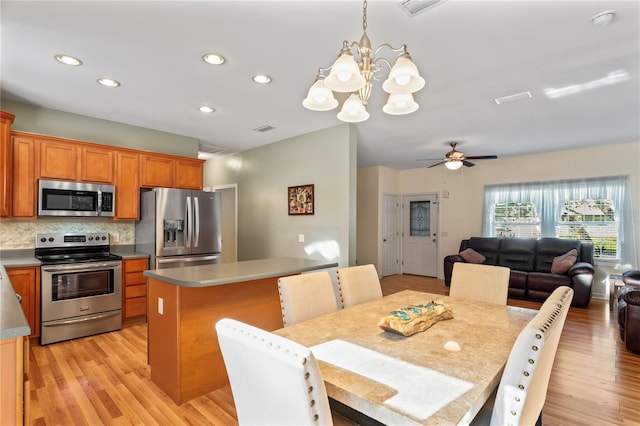 15613 Charmwood Dr, Hudson, FL 34667 - dining area featuring a chandelier, recessed lighting, light wood finished floors, and ceiling fan