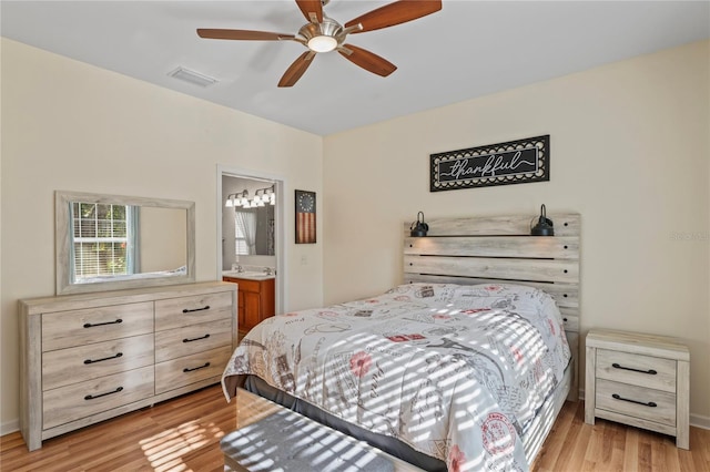 15613 Charmwood Dr, Hudson, FL 34667 - bedroom featuring light wood-style flooring, connected bathroom, and ceiling fan