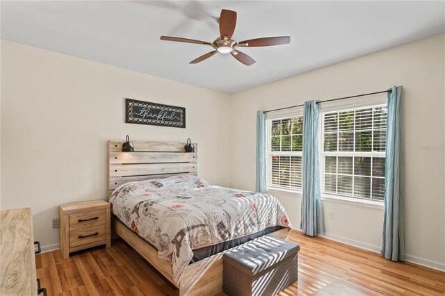 15613 Charmwood Dr, Hudson, FL 34667 - bedroom with wood finished floors, baseboards, and ceiling fan