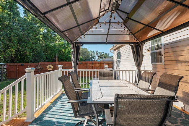 15613 Charmwood Dr, Hudson, FL 34667 - wooden terrace with outdoor dining area, a gazebo, and a fenced backyard