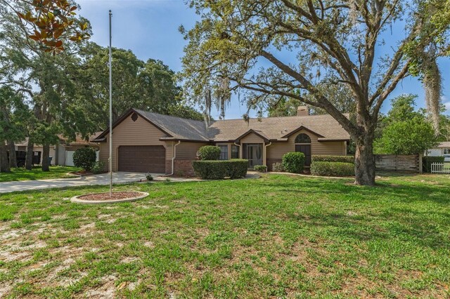 8402 Lake Hill Ct, Spring Hill, FL 34608 - single story home with an attached garage, driveway, and a chimney