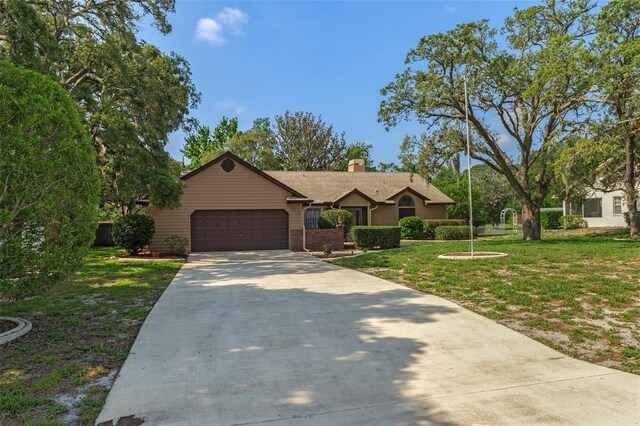 8402 Lake Hill Ct, Spring Hill, FL 34608 - ranch-style home featuring a garage, driveway, a front yard, a chimney, and brick siding