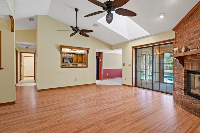 8402 Lake Hill Ct, Spring Hill, FL 34608 - unfurnished living room with light wood finished floors, ceiling fan, lofted ceiling, a fireplace, and baseboards