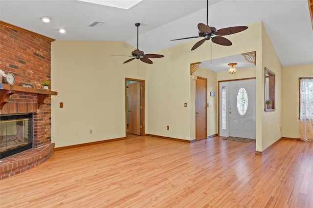 8402 Lake Hill Ct, Spring Hill, FL 34608 - unfurnished living room with vaulted ceiling, a ceiling fan, light wood-type flooring, baseboards, and a fireplace