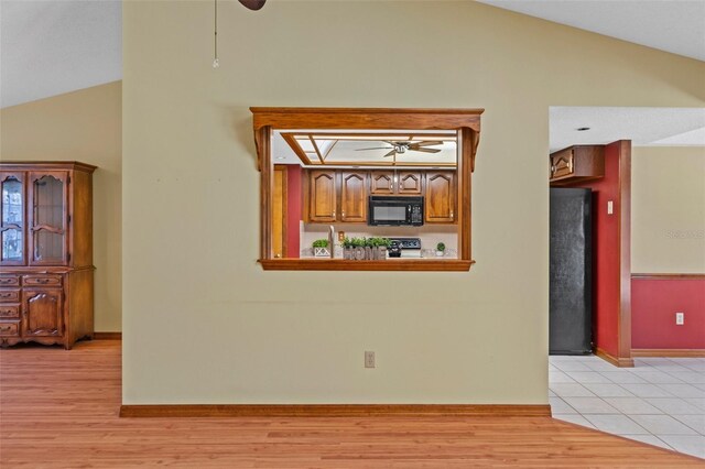 8402 Lake Hill Ct, Spring Hill, FL 34608 - interior space featuring lofted ceiling, ceiling fan, light wood-type flooring, and baseboards
