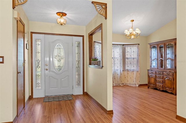 8402 Lake Hill Ct, Spring Hill, FL 34608 - entryway featuring a chandelier, light wood finished floors, and baseboards