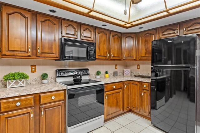 8402 Lake Hill Ct, Spring Hill, FL 34608 - kitchen with black appliances, light countertops, brown cabinetry, light tile patterned flooring, and decorative backsplash