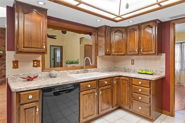 8402 Lake Hill Ct, Spring Hill, FL 34608 - kitchen with black dishwasher, a sink, light countertops, brown cabinetry, and decorative backsplash