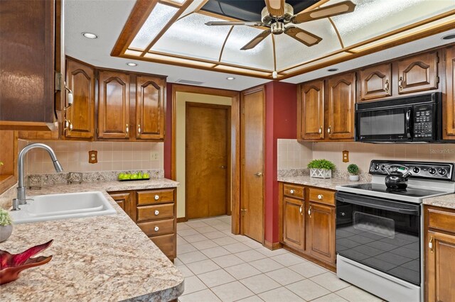 8402 Lake Hill Ct, Spring Hill, FL 34608 - kitchen featuring black microwave, electric range, a sink, light countertops, and recessed lighting
