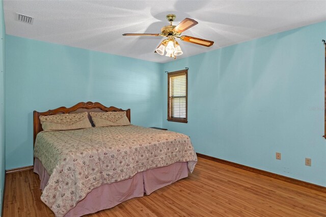 8402 Lake Hill Ct, Spring Hill, FL 34608 - bedroom featuring wood finished floors, baseboards, and ceiling fan
