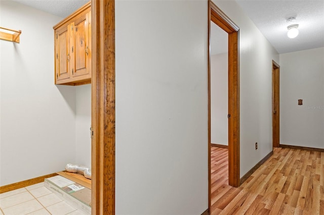 8402 Lake Hill Ct, Spring Hill, FL 34608 - hall featuring baseboards, light wood-style floors, and a textured ceiling