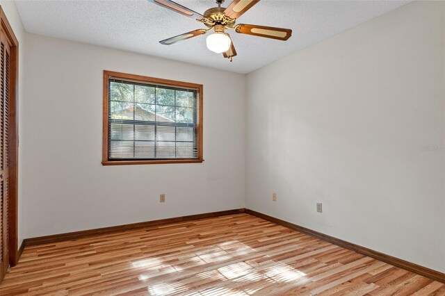 8402 Lake Hill Ct, Spring Hill, FL 34608 - unfurnished room with light wood-style floors, baseboards, and a ceiling fan