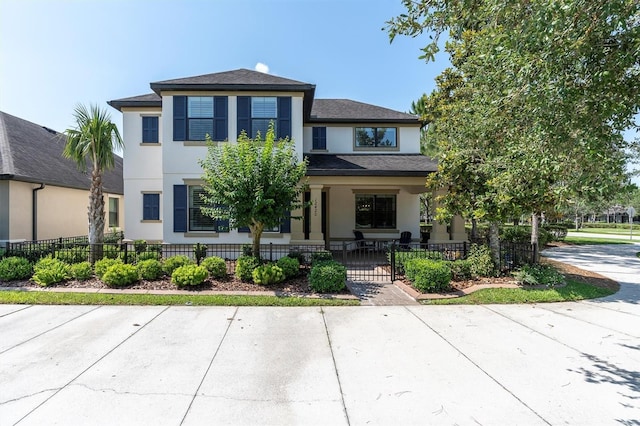 12420 Rangeland Blvd, Odessa, FL 33556 - view of front of home featuring stucco siding, a fenced front yard, and a porch