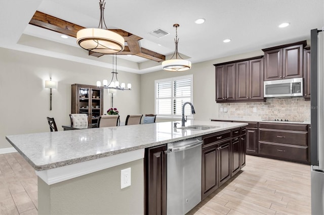 12420 Rangeland Blvd, Odessa, FL 33556 - kitchen featuring a sink, appliances with stainless steel finishes, decorative backsplash, light wood-style flooring, and recessed lighting