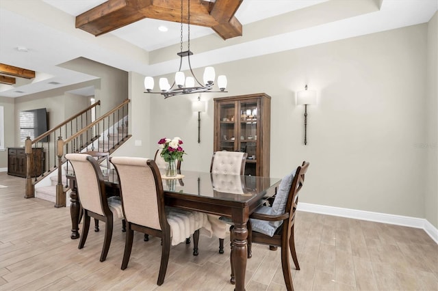 12420 Rangeland Blvd, Odessa, FL 33556 - dining room with a tray ceiling, light wood-style flooring, a chandelier, coffered ceiling, and baseboards
