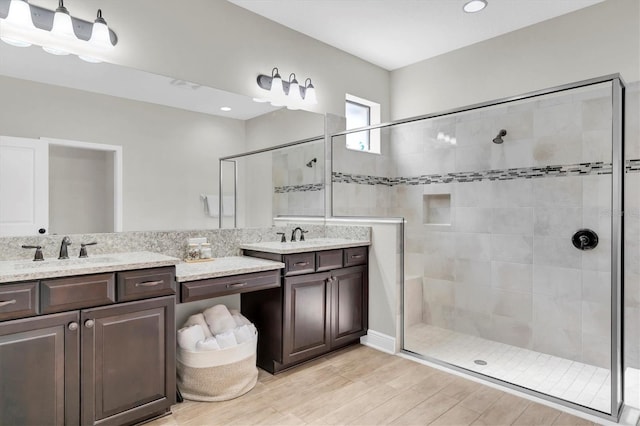 12420 Rangeland Blvd, Odessa, FL 33556 - bathroom featuring a tile shower, vanity, wood finished floors, and recessed lighting