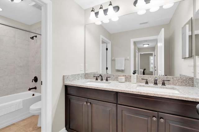 12420 Rangeland Blvd, Odessa, FL 33556 - bathroom featuring toilet, tub / shower combination, double vanity, and tile patterned flooring
