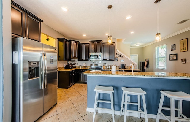 14008 Lugano Ct, Hudson, FL 34669 - kitchen featuring appliances with stainless steel finishes, crown molding, light stone counters, a kitchen breakfast bar, and dark brown cabinets