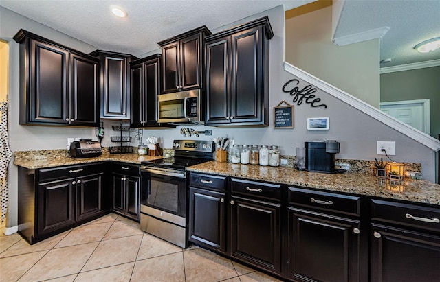 14008 Lugano Ct, Hudson, FL 34669 - kitchen featuring stainless steel appliances, a textured ceiling, dark cabinets, crown molding, and stone countertops