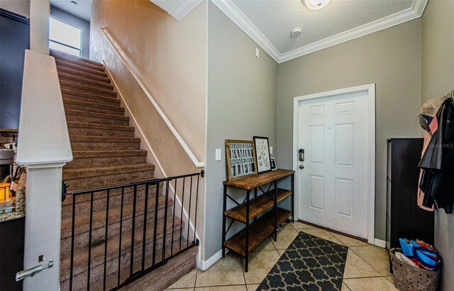 14008 Lugano Ct, Hudson, FL 34669 - foyer entrance with crown molding, stairway, light tile patterned floors, baseboards, and a textured ceiling