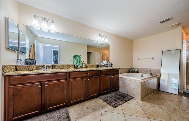 14008 Lugano Ct, Hudson, FL 34669 - full bath featuring double vanity, a garden tub, tile patterned floors, a shower with shower door, and a textured ceiling