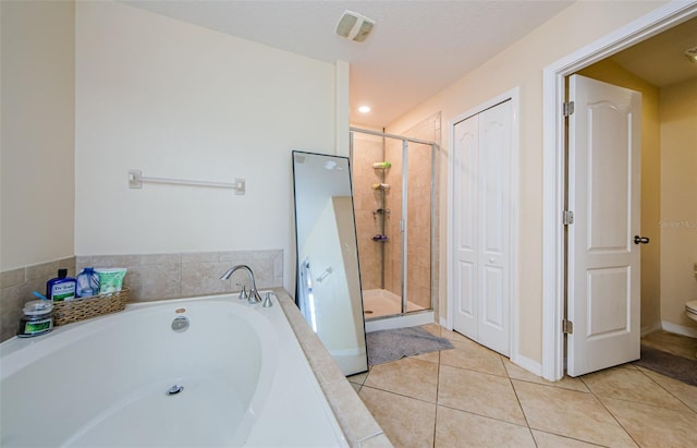 14008 Lugano Ct, Hudson, FL 34669 - bathroom featuring a garden tub, a stall shower, tile patterned floors, and toilet