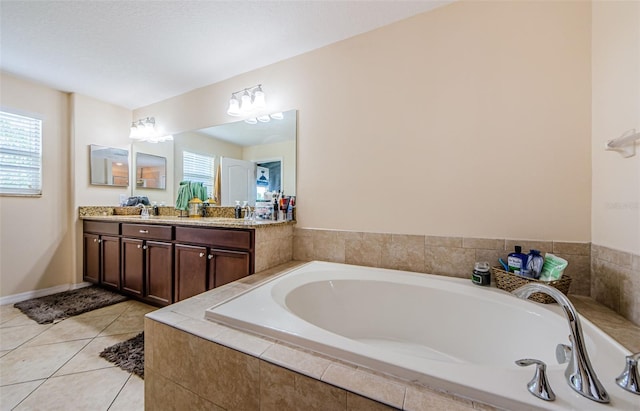14008 Lugano Ct, Hudson, FL 34669 - bathroom featuring double vanity, a bath, and tile patterned floors