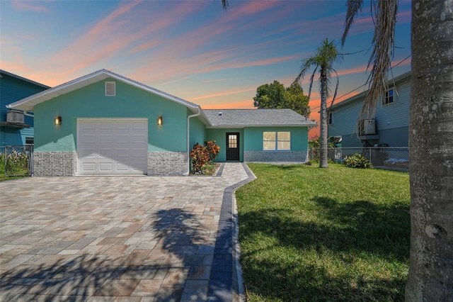 4482 Kingston Dr, Hernando Beach, FL 34607 - view of front of home featuring a garage, decorative driveway, and stucco siding