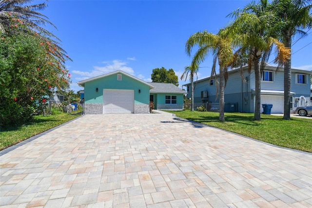 4482 Kingston Dr, Hernando Beach, FL 34607 - view of front of property with decorative driveway and a garage