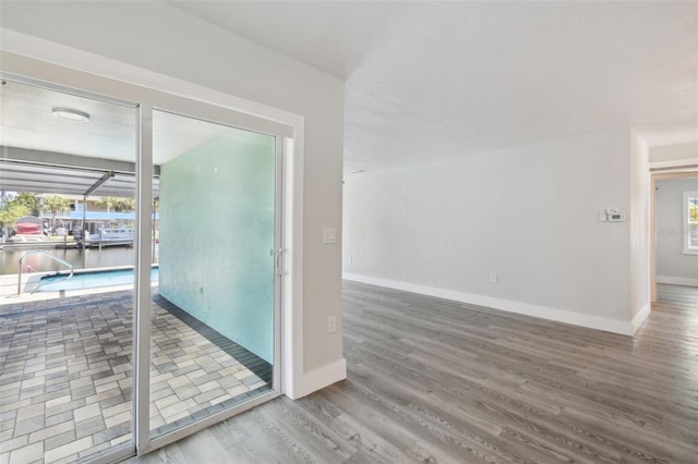 4482 Kingston Dr, Hernando Beach, FL 34607 - unfurnished room featuring wood finished floors, baseboards, and a water view