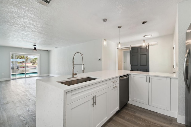 4482 Kingston Dr, Hernando Beach, FL 34607 - kitchen featuring a sink, dark wood-style floors, stainless steel appliances, ceiling fan, and light countertops