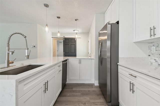 4482 Kingston Dr, Hernando Beach, FL 34607 - kitchen with stainless steel appliances, a sink, white cabinets, wood finished floors, and light countertops