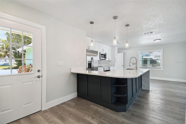 4482 Kingston Dr, Hernando Beach, FL 34607 - kitchen with stainless steel appliances, a sink, baseboards, white cabinets, and open shelves