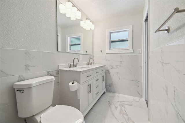 4482 Kingston Dr, Hernando Beach, FL 34607 - full bath with tile walls, marble finish flooring, toilet, double vanity, and a wainscoted wall