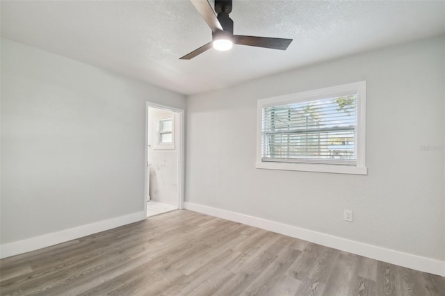 4482 Kingston Dr, Hernando Beach, FL 34607 - spare room featuring baseboards, a ceiling fan, wood finished floors, and a textured ceiling