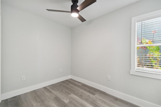 4482 Kingston Dr, Hernando Beach, FL 34607 - unfurnished room featuring a ceiling fan, healthy amount of natural light, wood finished floors, and baseboards