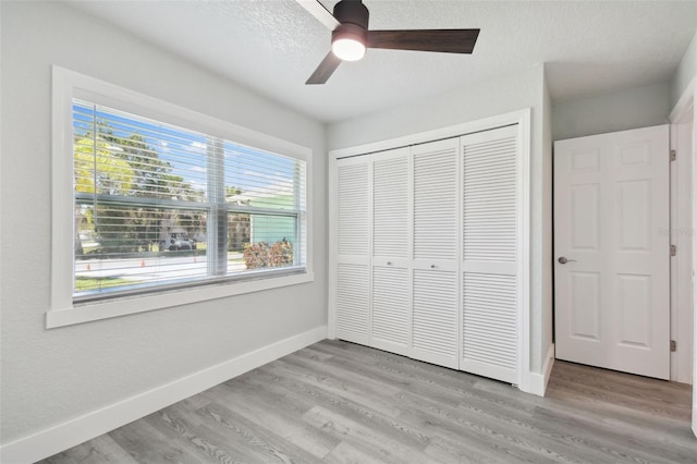 4482 Kingston Dr, Hernando Beach, FL 34607 - unfurnished bedroom featuring light wood-style floors, baseboards, a closet, and ceiling fan