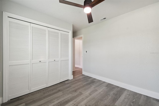 4482 Kingston Dr, Hernando Beach, FL 34607 - unfurnished bedroom with a closet, wood finished floors, baseboards, and ceiling fan