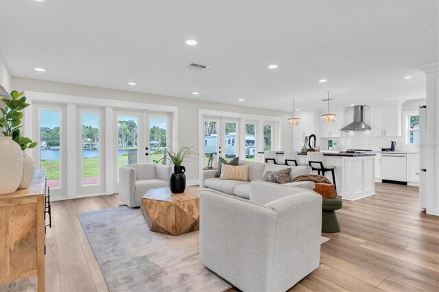 18102 Spencer Rd, Odessa, FL 33556 - living room with light wood-style flooring, recessed lighting, and a water view